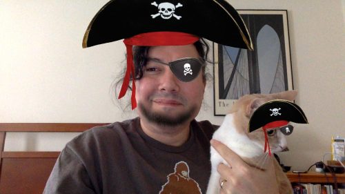 The author and cat, with pirate hats and eye patches superimposed by a Snapchat filter