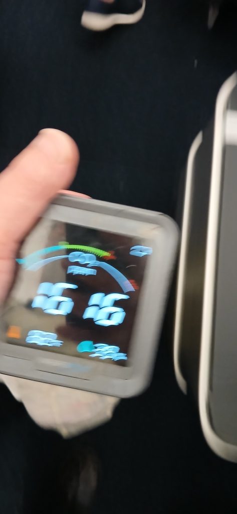 In an airplane seat, an INKBIRD carbon dioxide monitor reads 1616 parts per million, 85 degrees Fahrenheit and 38% relative humidity.