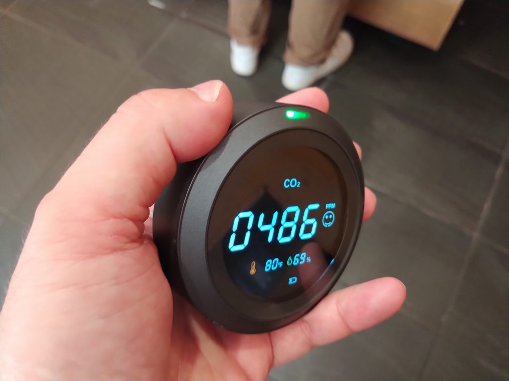 A carbon dioxide monitor reads 486 parts per million, at 80 degrees Fahrenheit and 69% relative humidity.